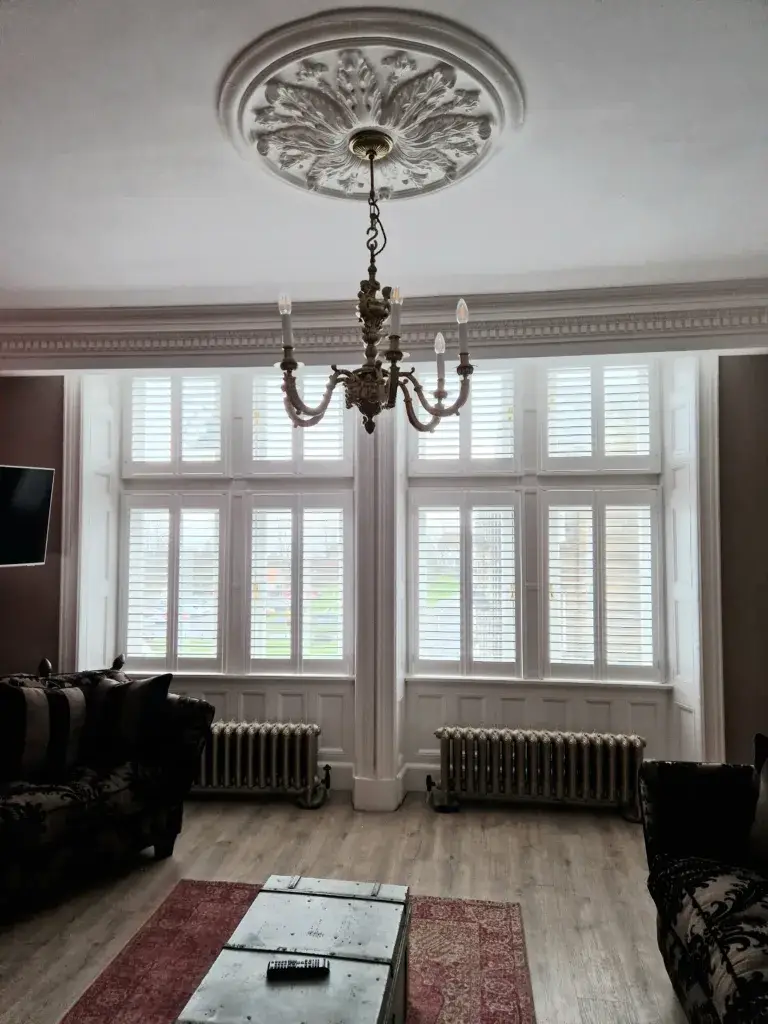 shutters in livingroom with light fixture